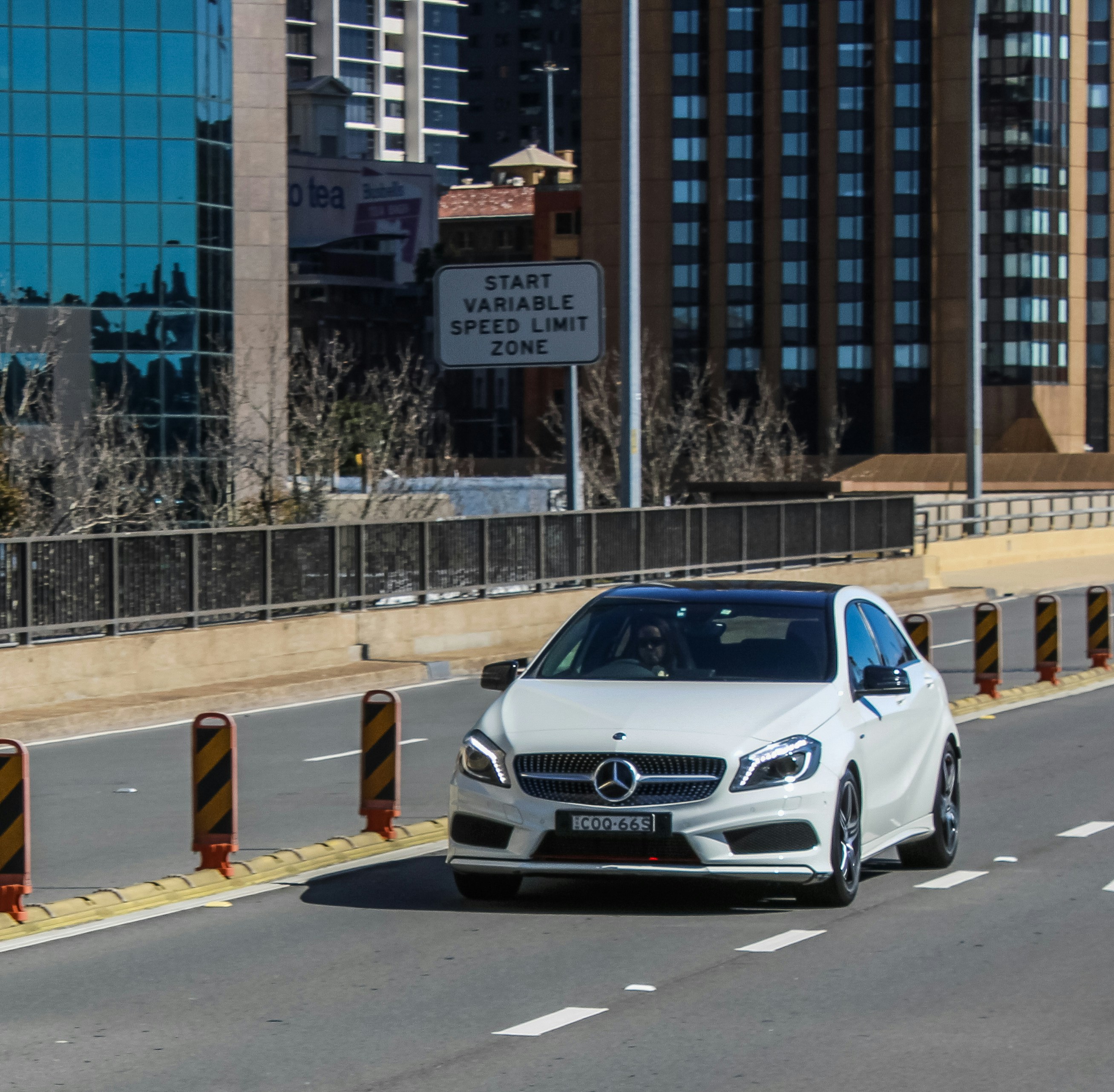 white mercedes benz coupe on road during daytime