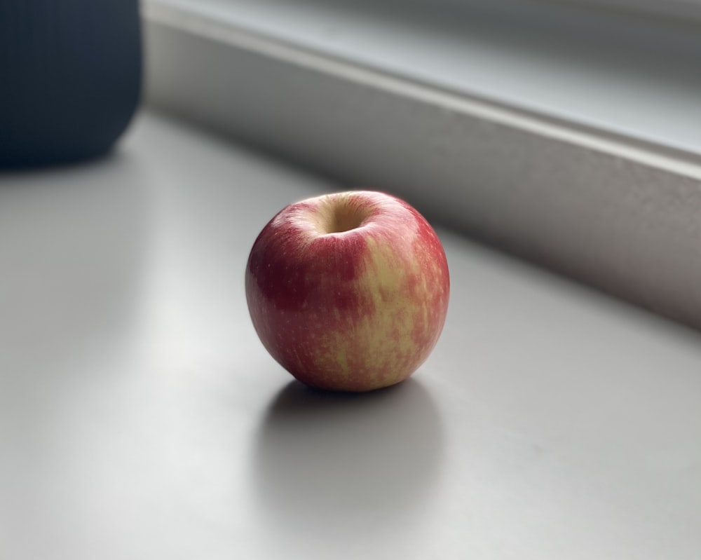 red apple on white table