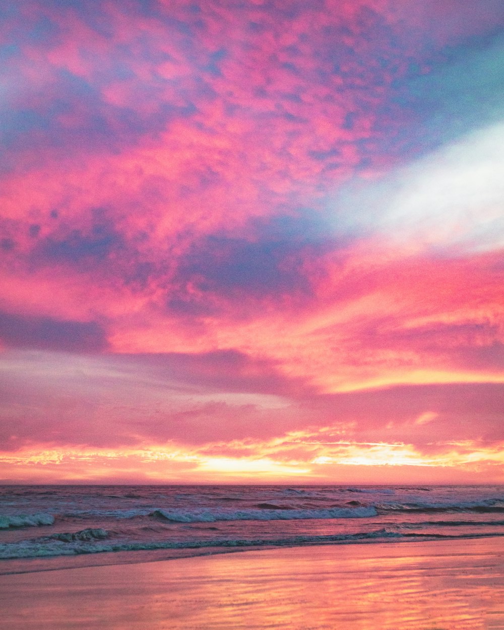 body of water under cloudy sky during sunset