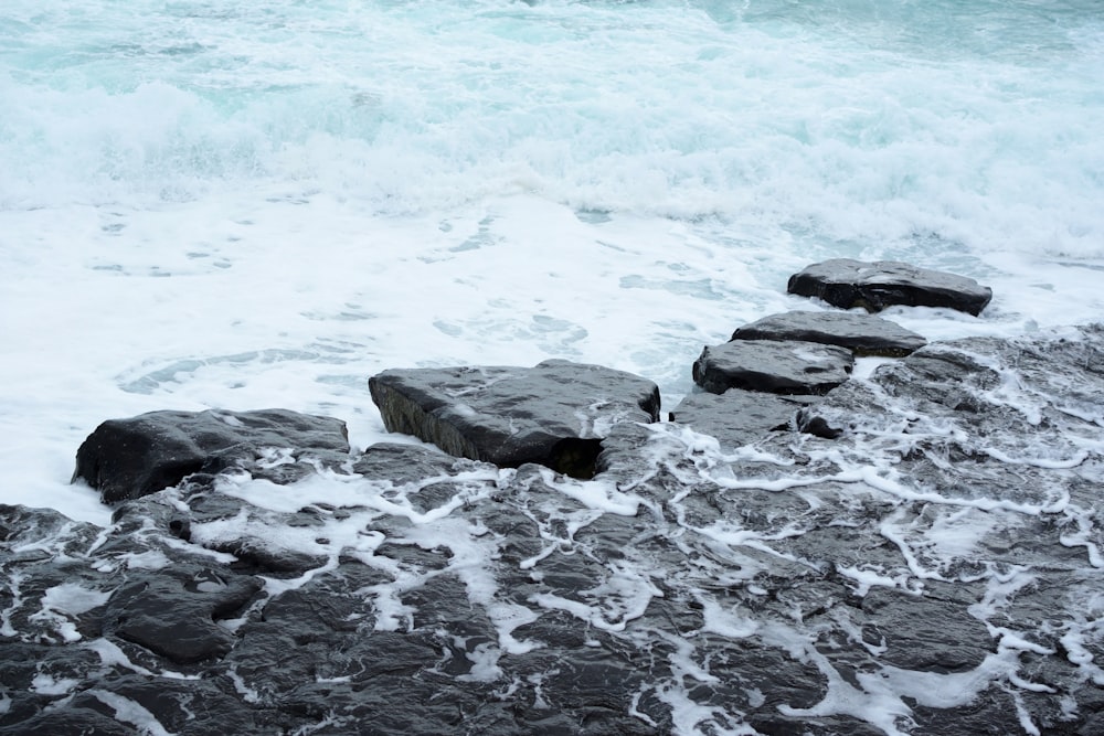 gray rocks on seashore during daytime