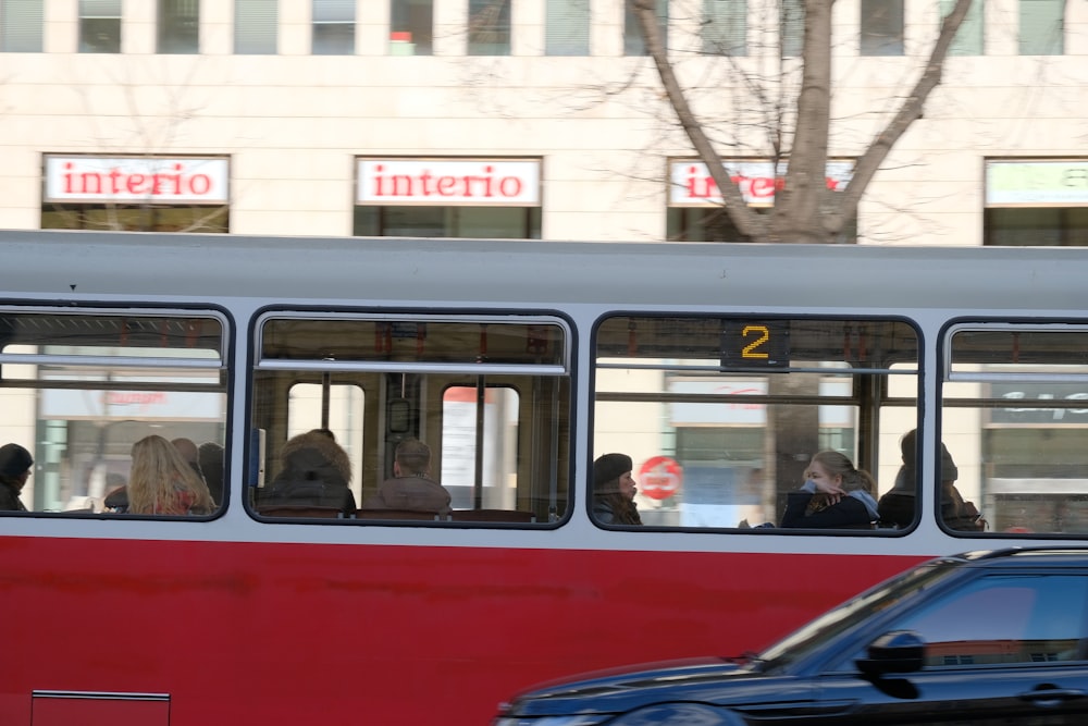 red and white bus on road during daytime