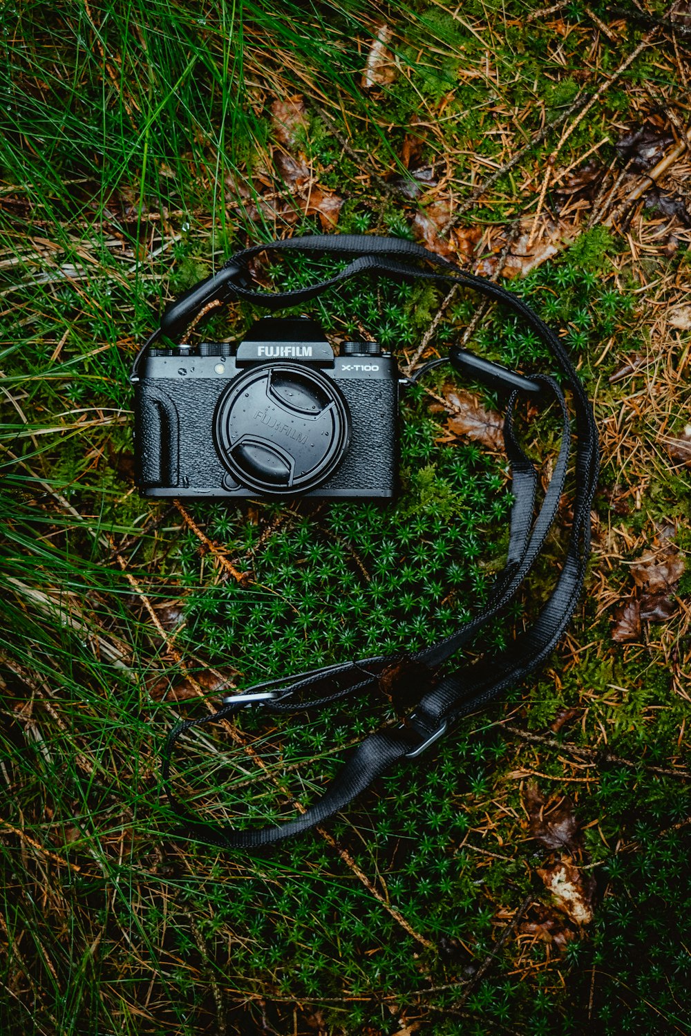 black nikon dslr camera on green grass