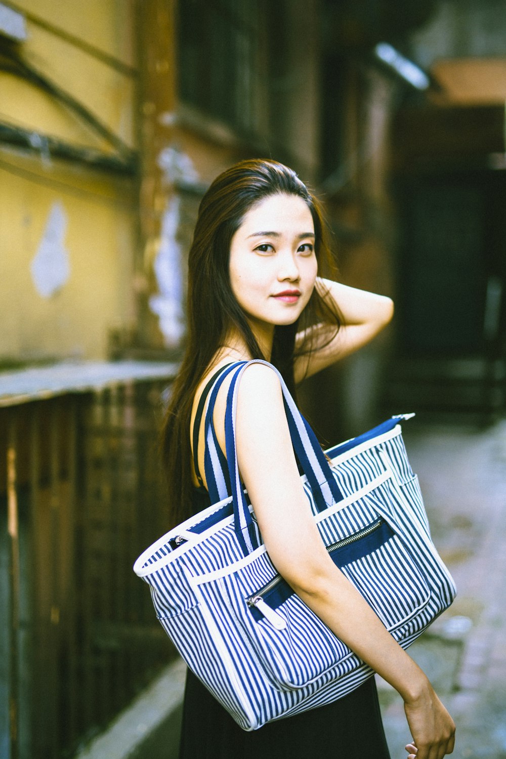 woman in black and white striped sleeveless dress