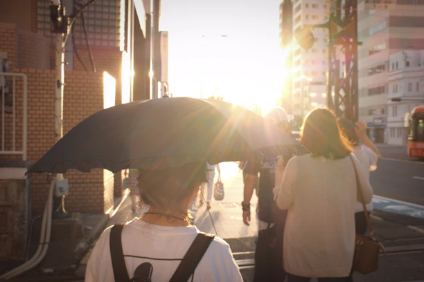 A group of happy travelers exploring a vibrant city street at sunset.
