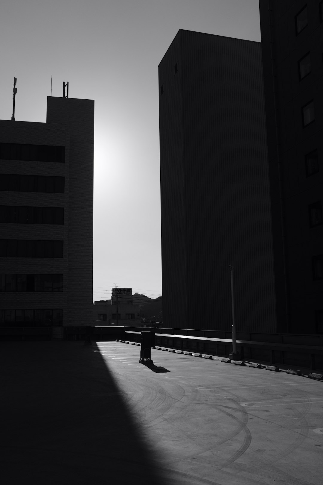 man in black jacket walking on sidewalk during night time