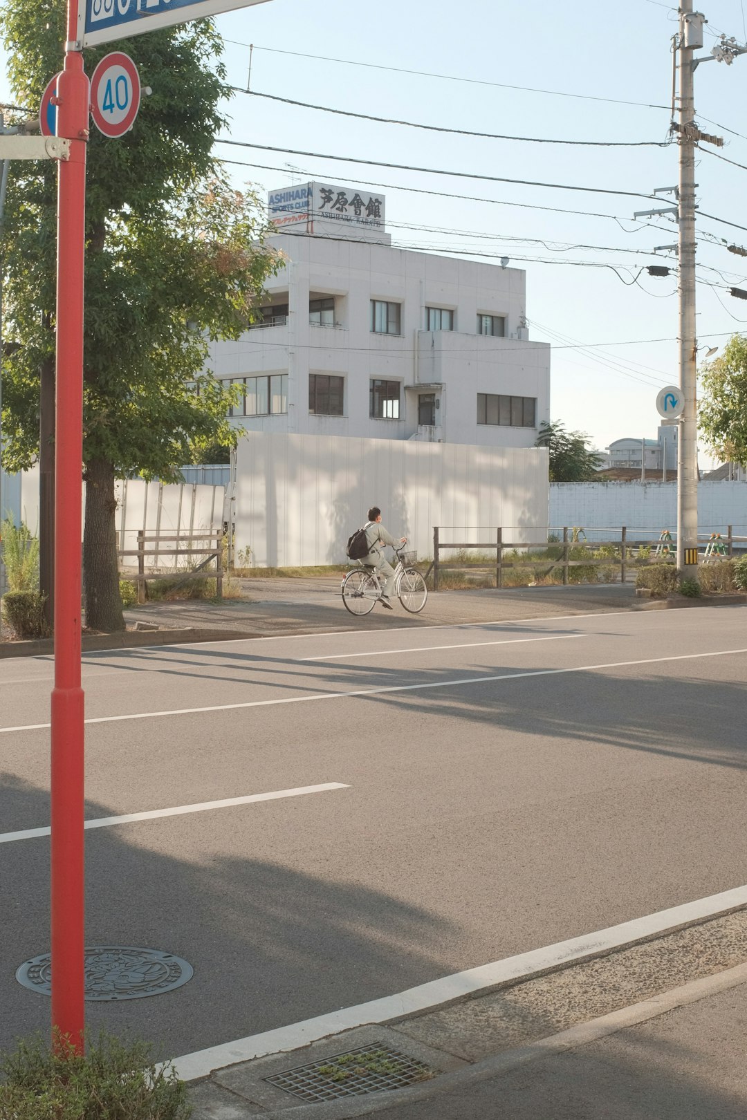 man in black jacket riding bicycle on road during daytime