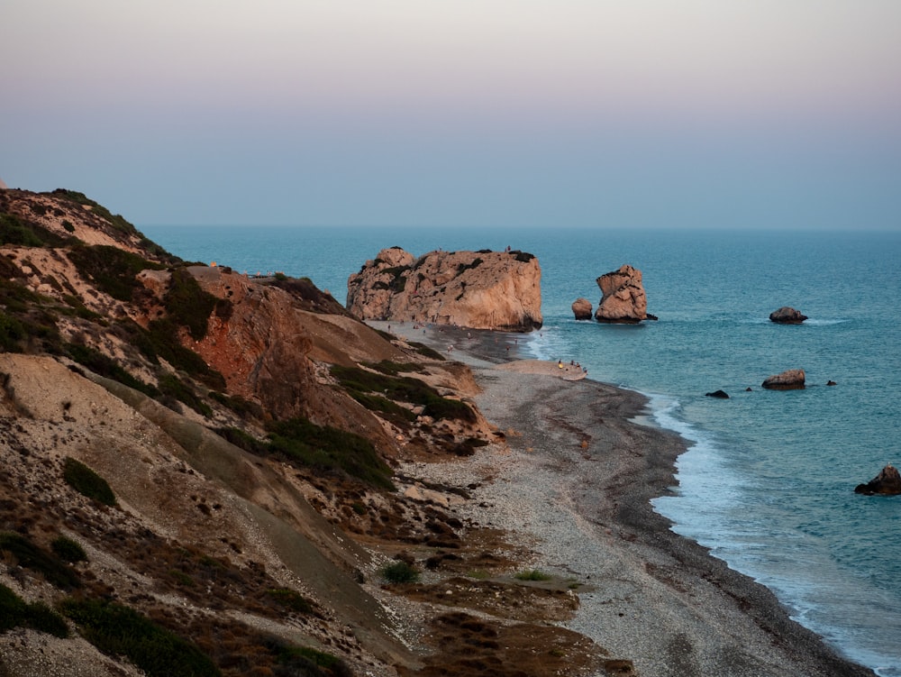 brown rock formation on sea during daytime