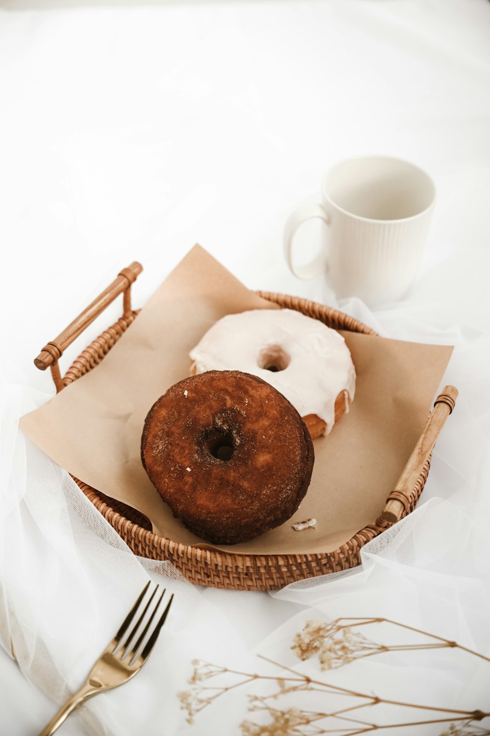 chocolate chip cookies on brown paper bag beside white ceramic mug