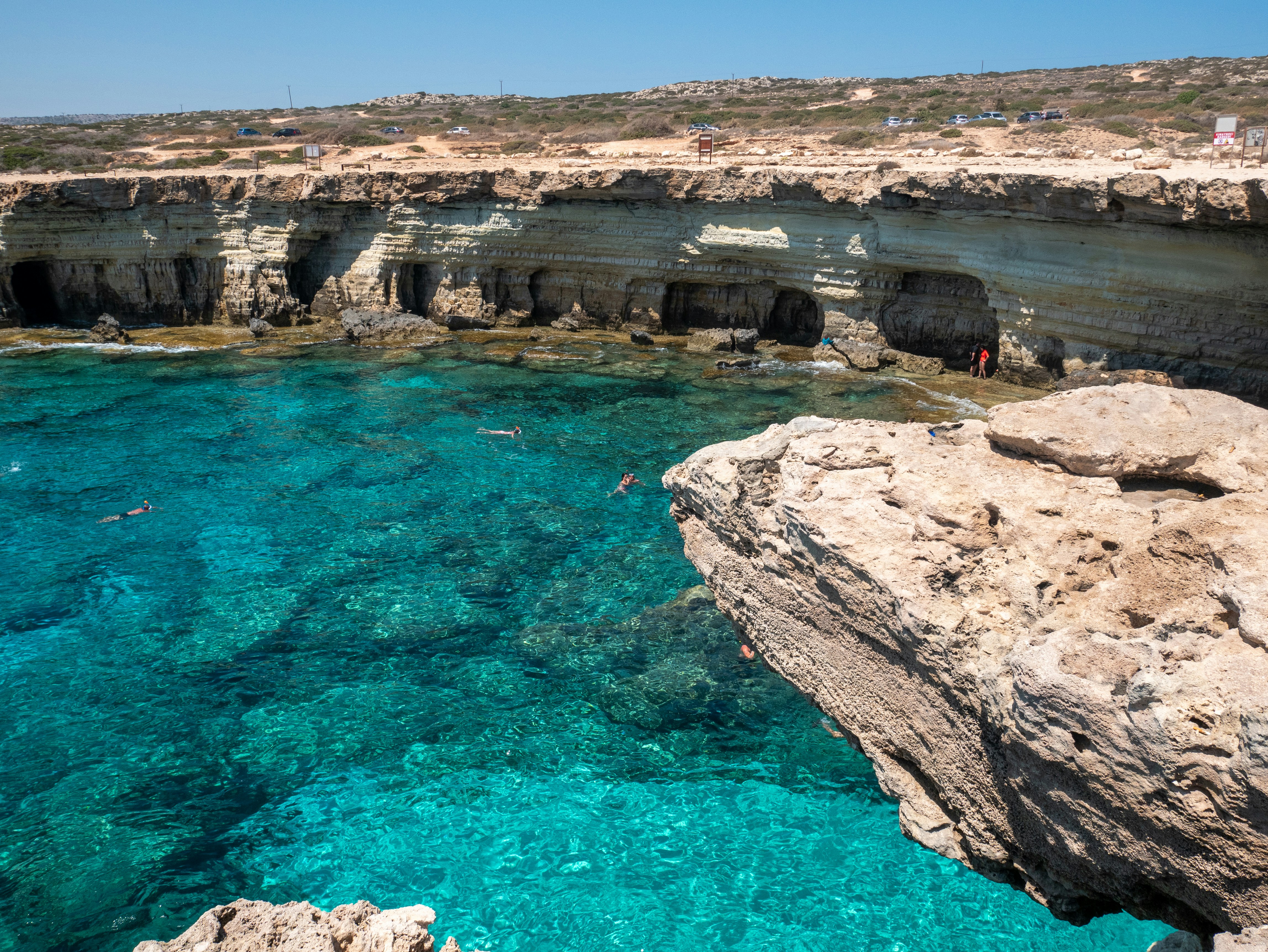 brown rock formation near body of water during daytime