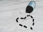 black plastic bottle on white textile