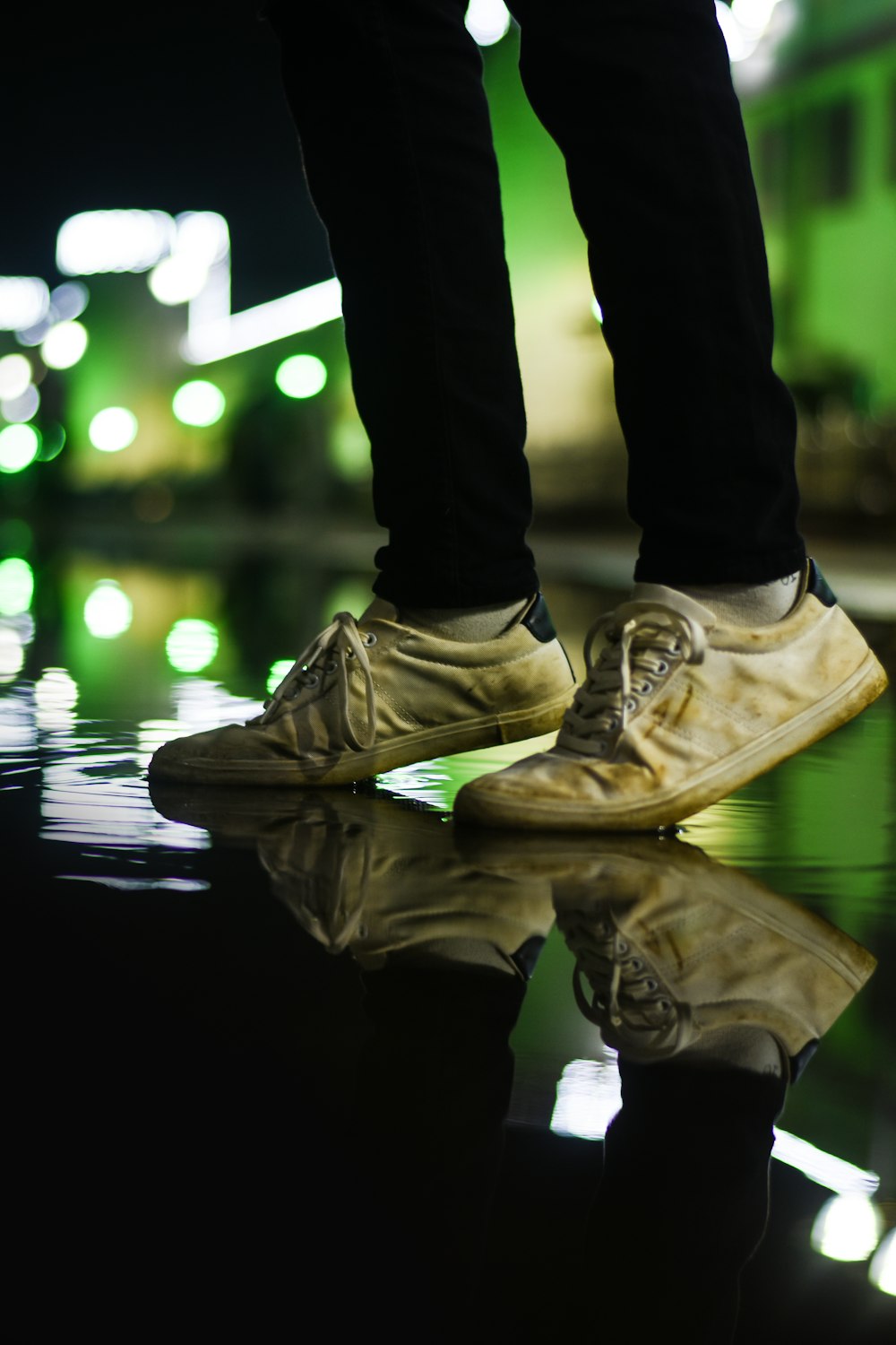 person in black pants wearing brown and white nike sneakers