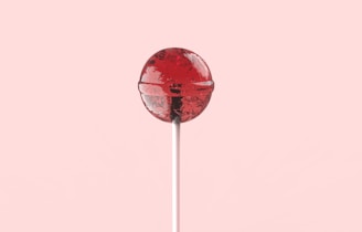 red and white lollipop on white stick