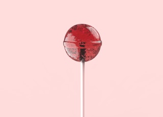 red and white lollipop on white stick