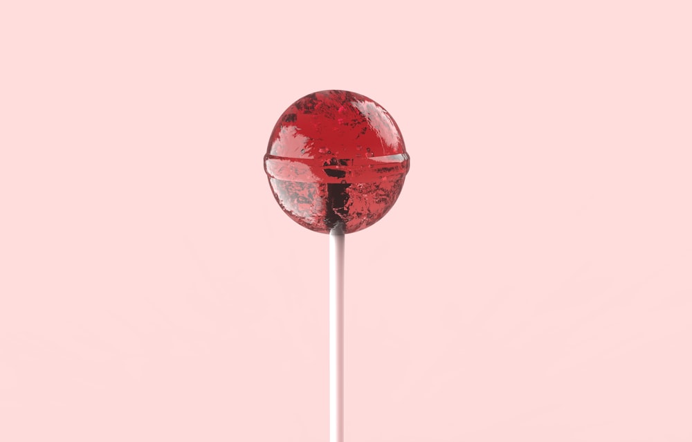 red and white lollipop on white stick