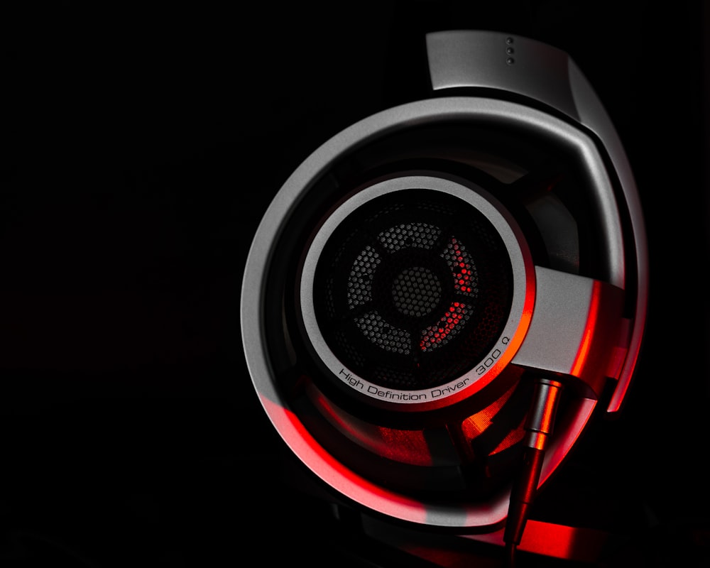 red and black headphones on black surface
