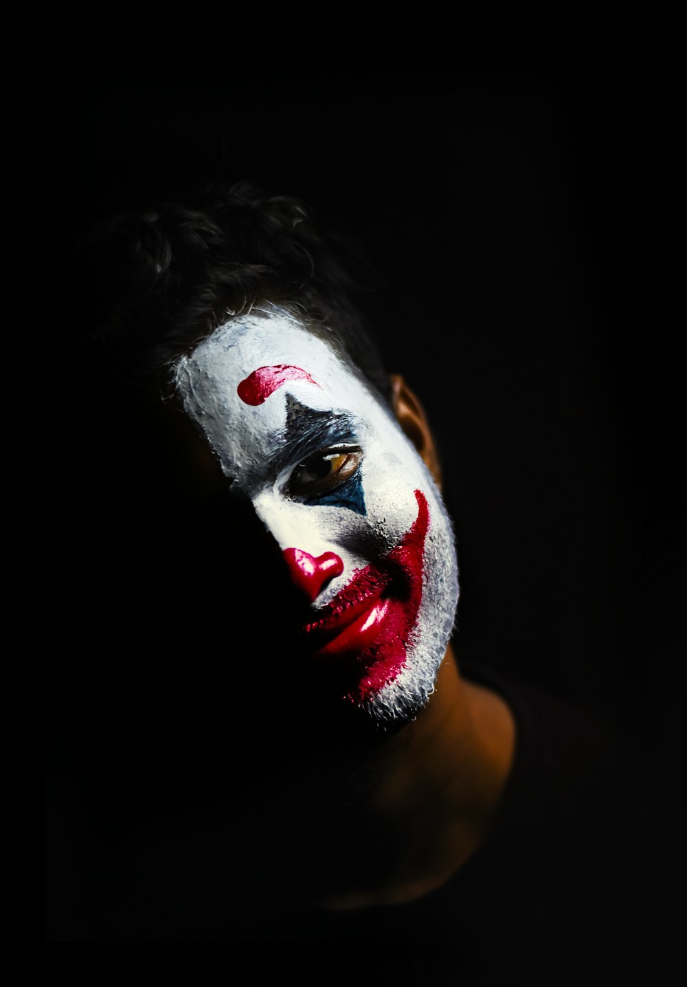 person with red and white face paint