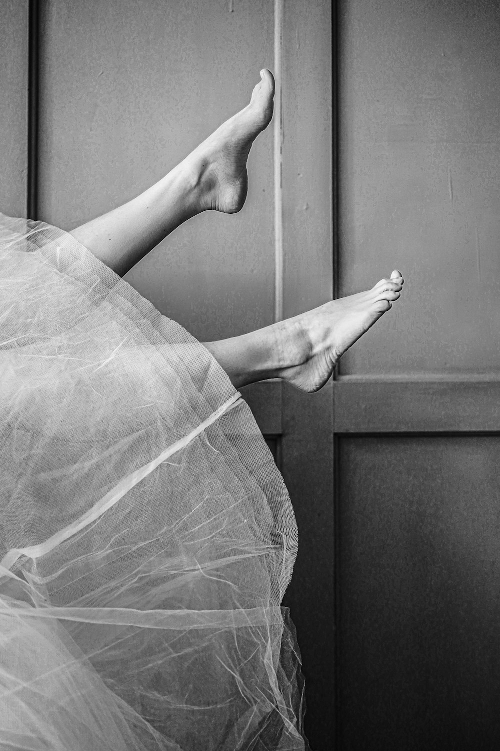 grayscale photo of persons feet on glass