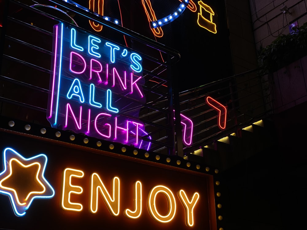 a neon sign that says enjoy and let's drink all night