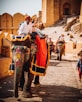 man in white long sleeve shirt riding elephant during daytime