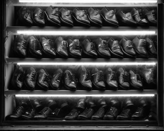 black leather boots on brown wooden table