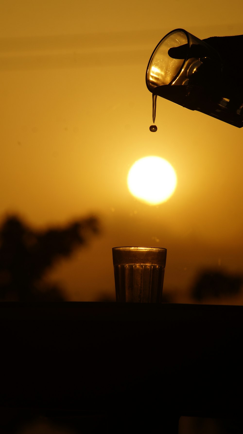 clear drinking glass with water during sunset
