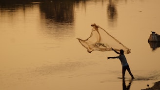a fisherman casting his net 