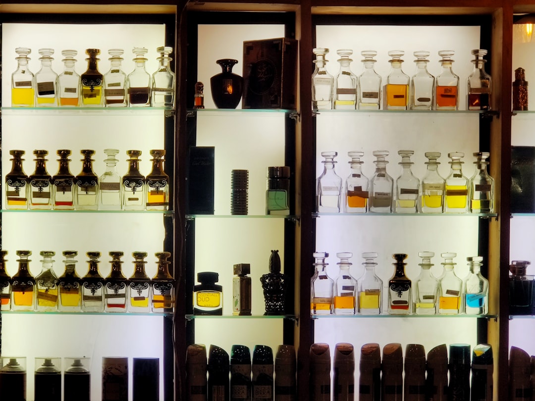bottles on brown wooden shelf,