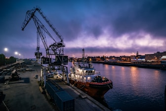 white and red boat on dock during night time