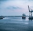 black ship on sea under white sky during daytime