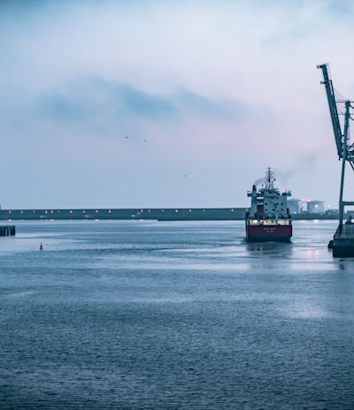 black ship on sea under white sky during daytime