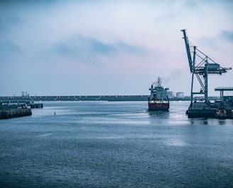 black ship on sea under white sky during daytime