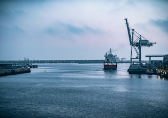 black ship on sea under white sky during daytime