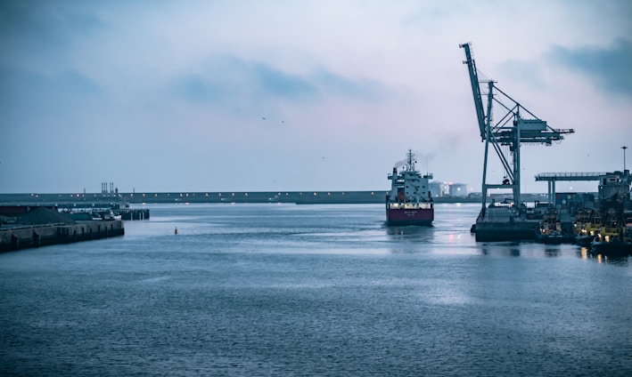 black ship on sea under white sky during daytime