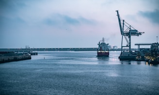 black ship on sea under white sky during daytime