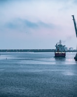 black ship on sea under white sky during daytime