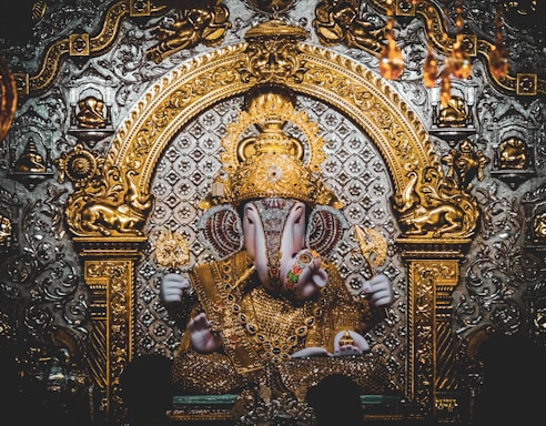 gold and blue hindu deity figurine