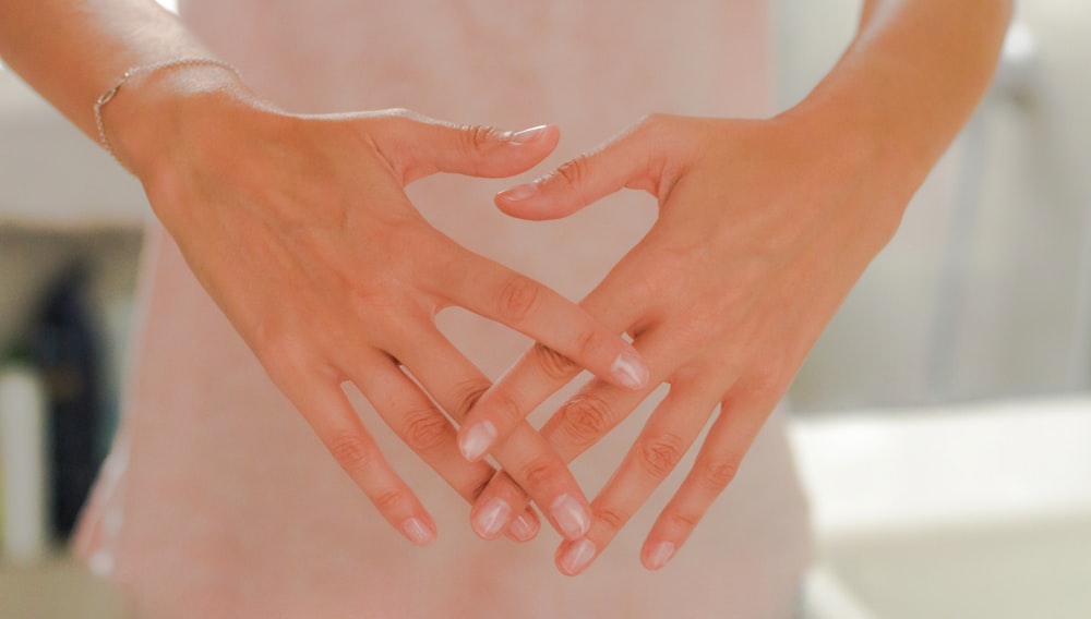 persons hand on white textile