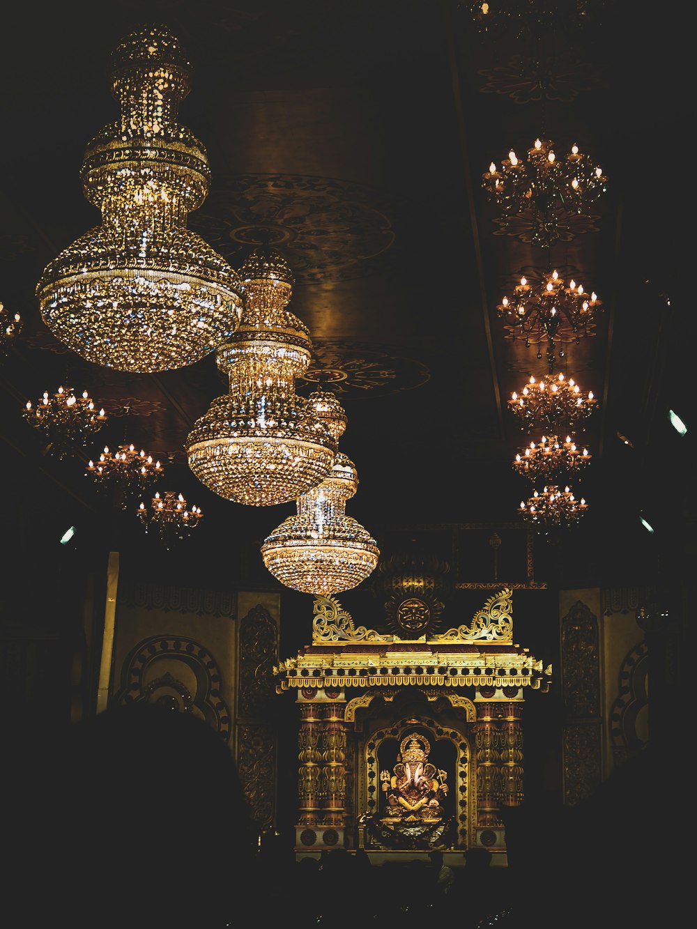 brass and crystal chandelier turned on during nighttime