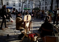 people sitting on chair near road during daytime