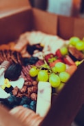 A close-up of a nutritious box lunch with fruits.