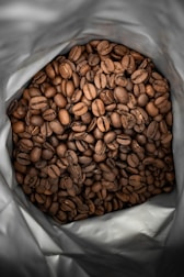 brown coffee beans on white plastic pack