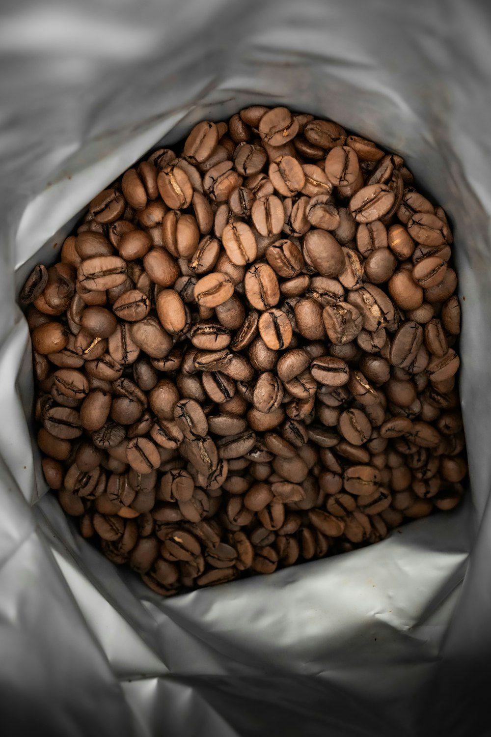 brown coffee beans on white plastic pack