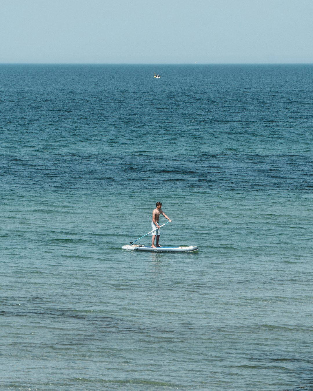 woman in pink bikini riding white surfboard on sea during daytime