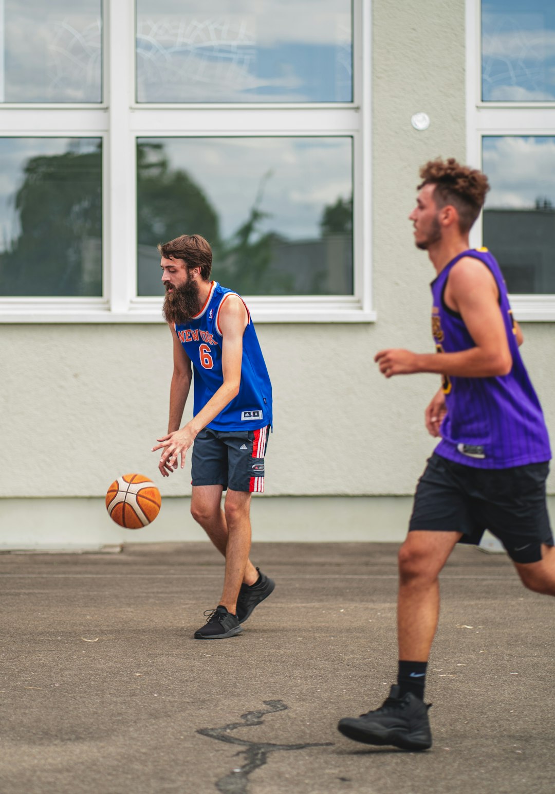 man in blue jersey shirt playing basketball