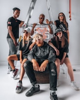 Group of friends wearing exa streetwear, laughing and walking through a futuristic cityscape.