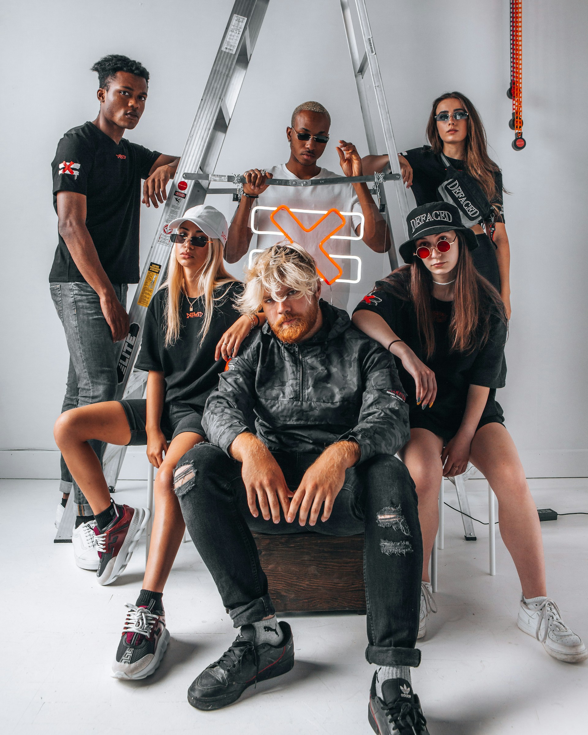 A dynamic shot of a group of creators wearing facs designs, embodying the spirit of individuality and style.