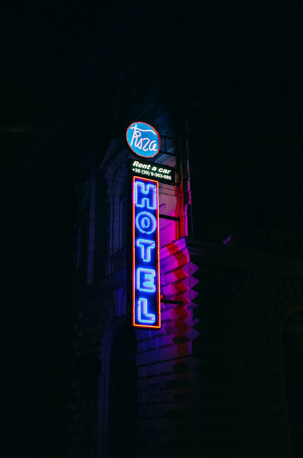 a neon sign on the side of a building