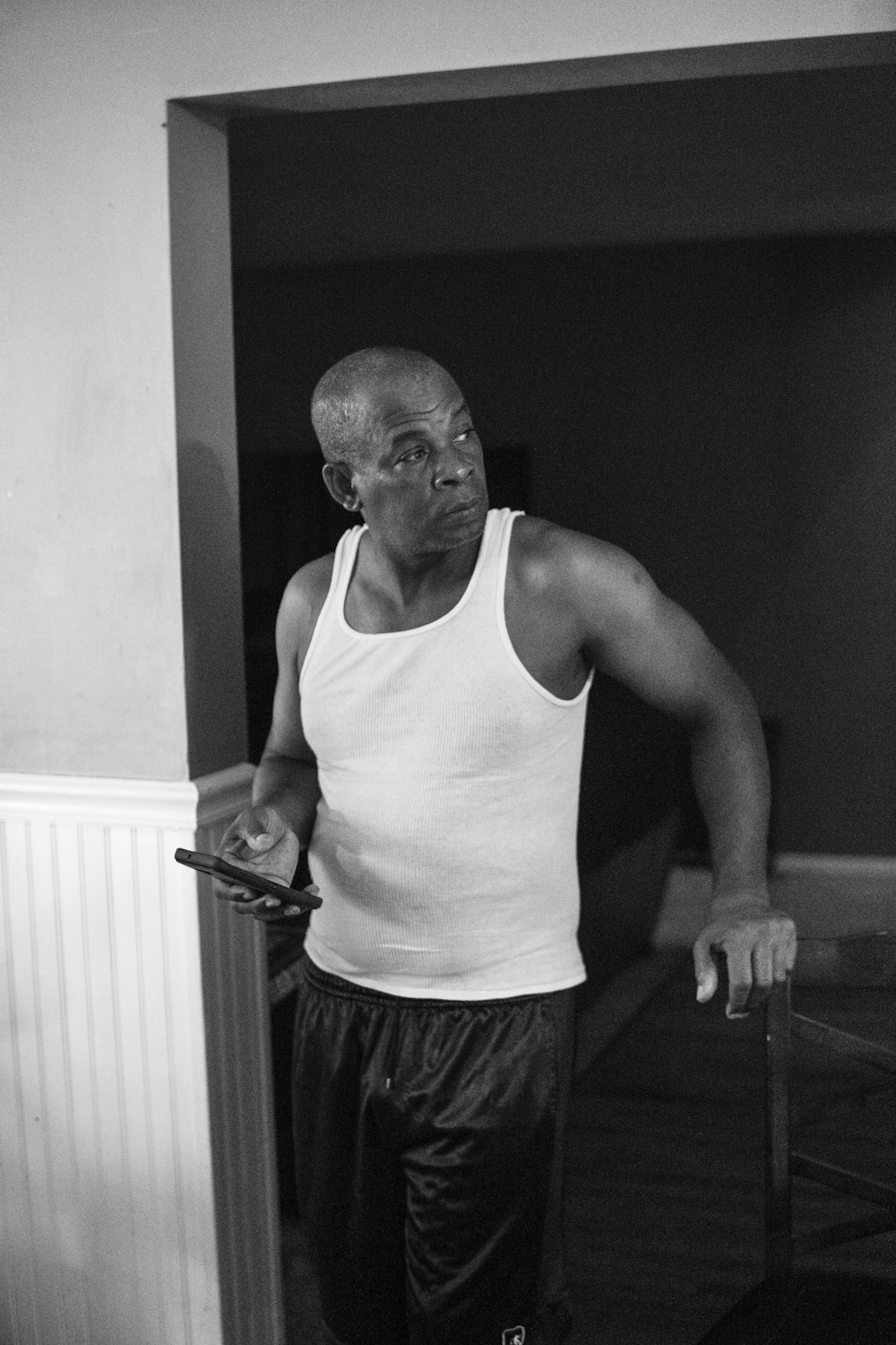 man in white tank top and black shorts