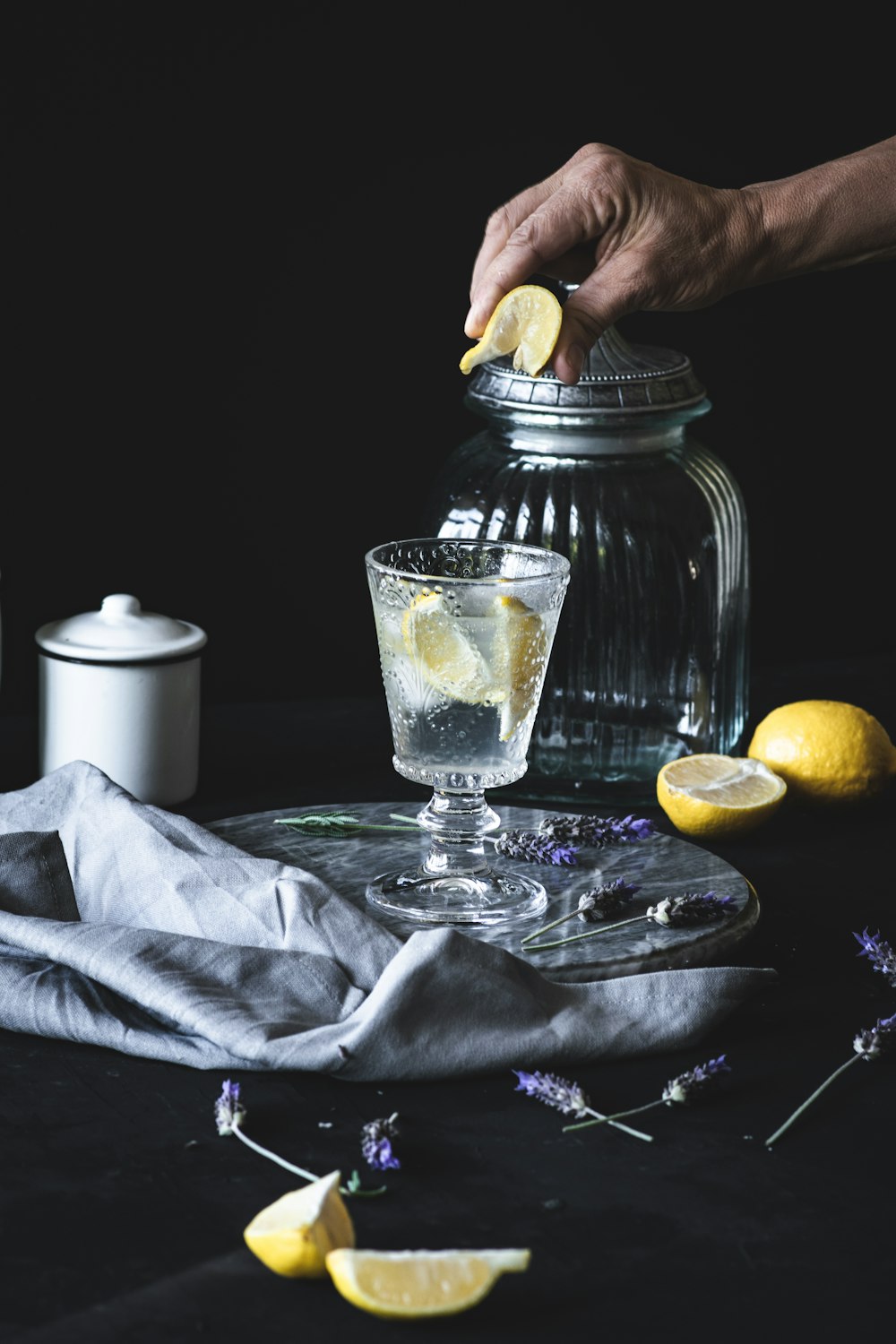 person pouring water on clear drinking glass