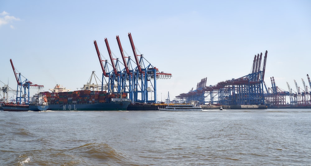 blue and red cargo ship on sea during daytime